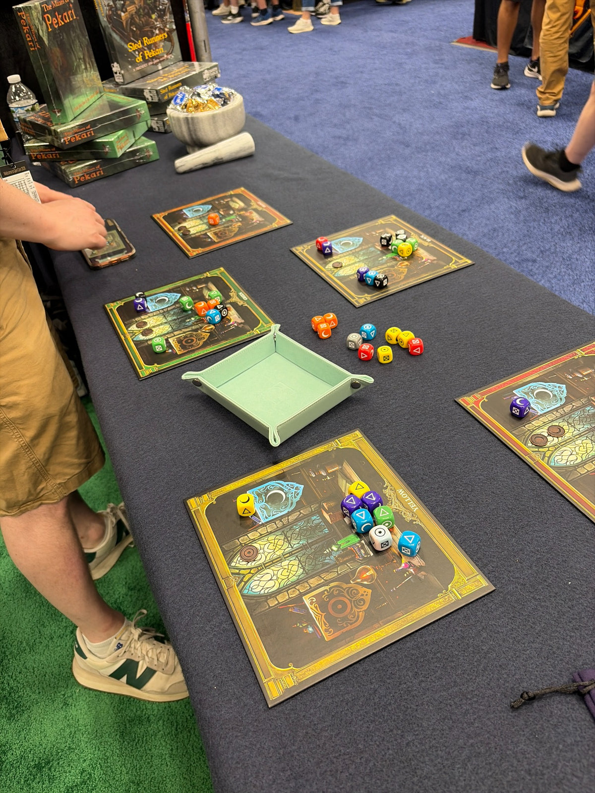 Close view of an Alchemy Workshop game in progress with player mats, dice, and dice tray