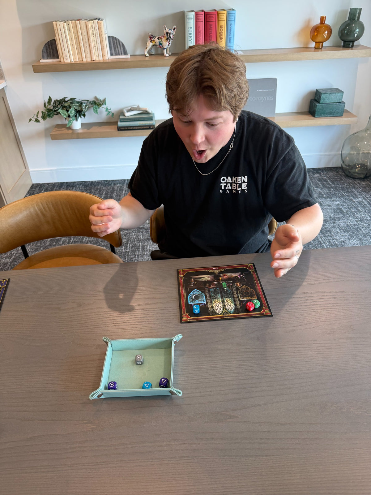 Player reacting to a roll while playing Alchemy Workshop at a table